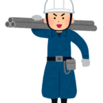 建設現場でパイプを持つとび職の人