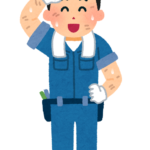 作業着を着て汗を拭う働く人